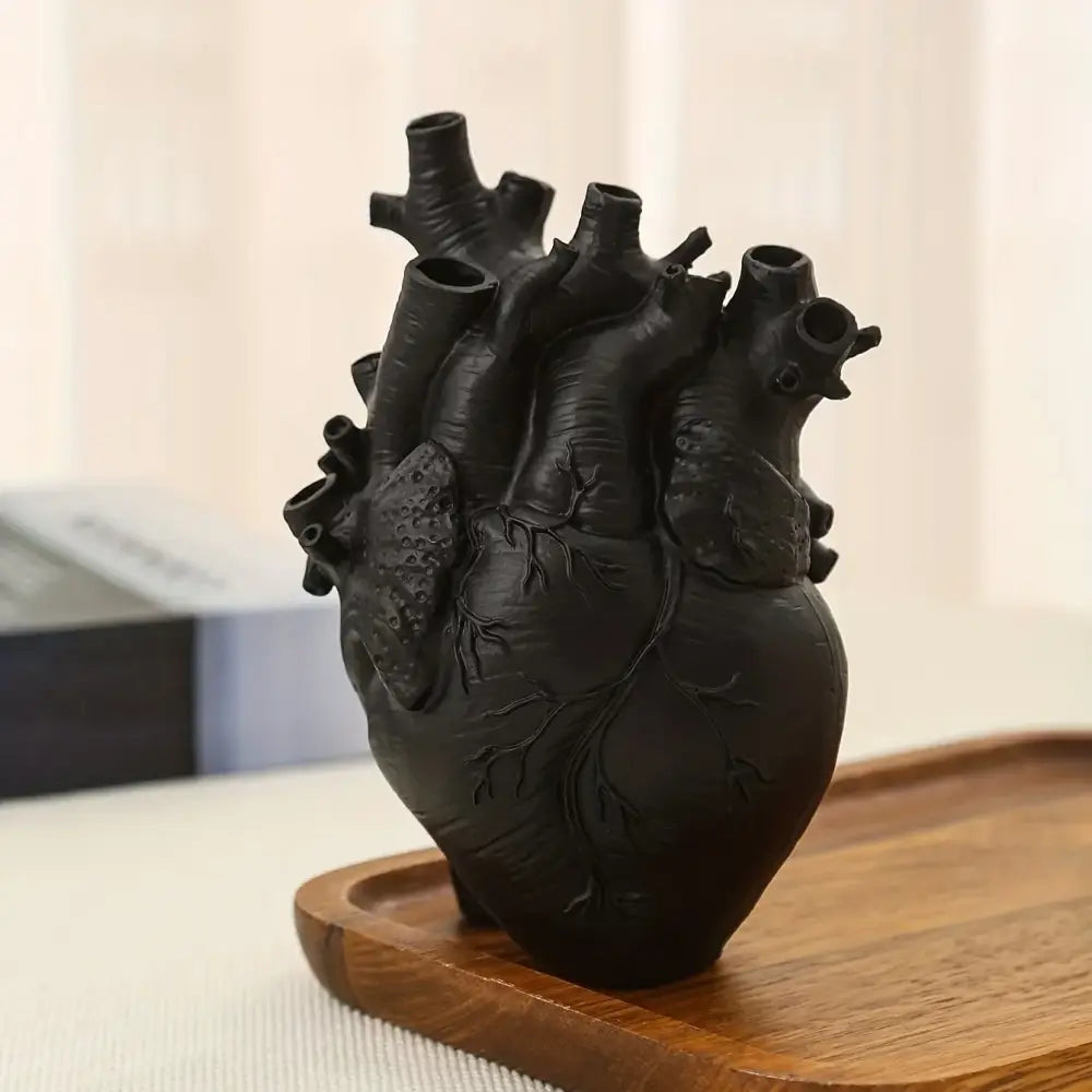 White anatomical heart vase with colorful flowers for living room