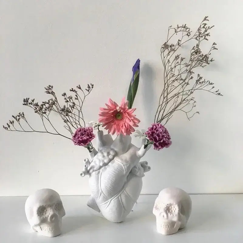White anatomical heart vase with branches for living room decor